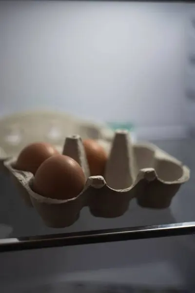A soft focus of three eggs in an egg carton