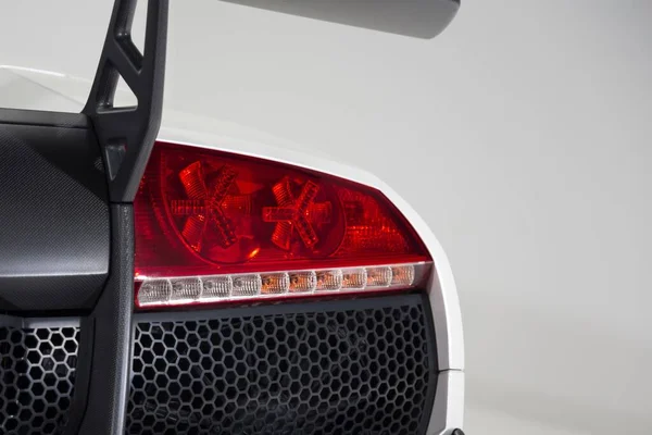 Closeup Red Tail Light White Luxury Car Isolated Grey Background — Stock Photo, Image