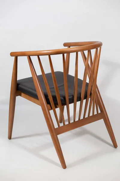 A behind shot of a wooden chair isolated on a white background