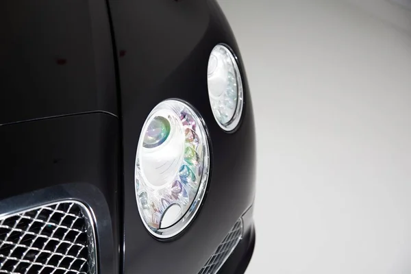 Closeup Headlight Black Luxury Car Lights Grey Background — Stock Photo, Image