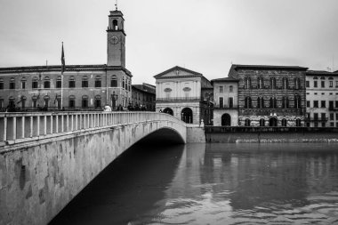 A black and white image of Ponte di Mezzo bridge in Pisa over Arno river Tuscany, Italy clipart