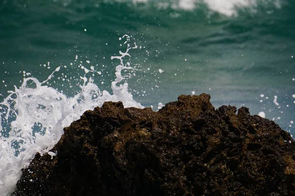 Fale Rozbijają Się Skałach Błękitnym Oceanem Nimi Pustą Plażą — Zdjęcie stockowe