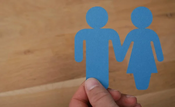 Closeup Shot Man Holding Blue Female Male Signs Wooden Background — Stock Photo, Image