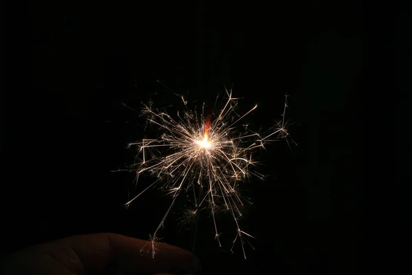 Sparks from a lit sparkler on a dark background — Stock Photo, Image