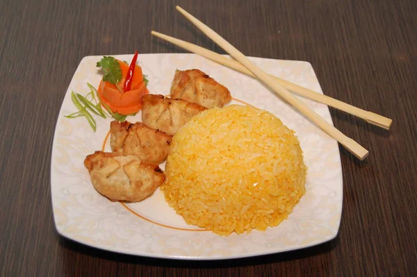 Fried dumplings and yellow rice meal