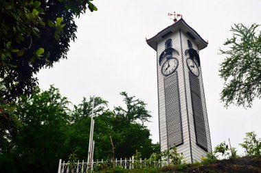KOTA KINABALU, MY - JUNE 21: Atkinson clock tower on June 21, 2016 in Kota Kinabalu, Malaysia. Atkinson Clock Tower is the oldest standing structure in Kota Kinabalu. It sits in solitary along Signal Hill Road. clipart