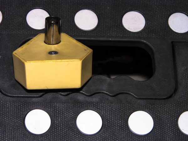 Ancient vintage splitter on folding construction stool. Close-up, narrow focus.