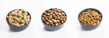 Fıstıklar, fındıklar ve bademler kasede, izole edilmiş beyaz arka plan