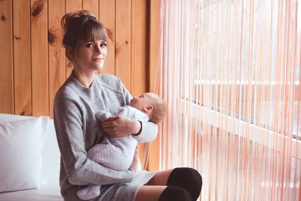 Smiling Mother Holding Sleeping Baby Hands Room Looking Camera — Stock Photo, Image