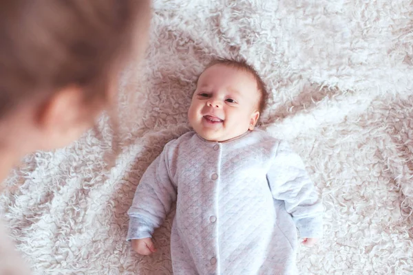 かわいい赤ちゃんの男の子の母親を見て ベッドで横に笑みを浮かべて お互いを見てる 目を覚ませ — ストック写真