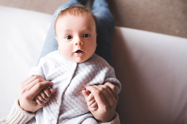 Funny Baby Lying Mother Hands Bed Closeup Looking Camera Motherhood — Stock Photo, Image