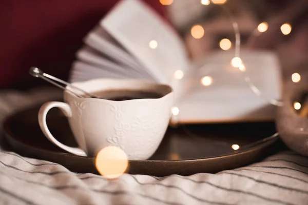 Cup Black Tea Wooden Tray Open Book Glowing Lights Background — Stock Photo, Image