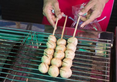 grill meatball on steel grating, a street food market clipart