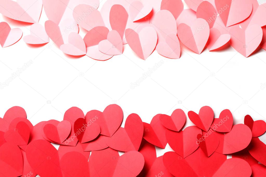 Cut out of red and pink paper hearts on red background isolated