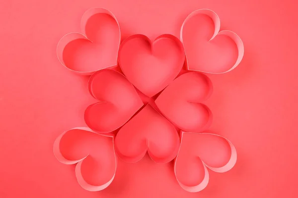 Four red and four pink of red paper hearts on red background top view — 스톡 사진