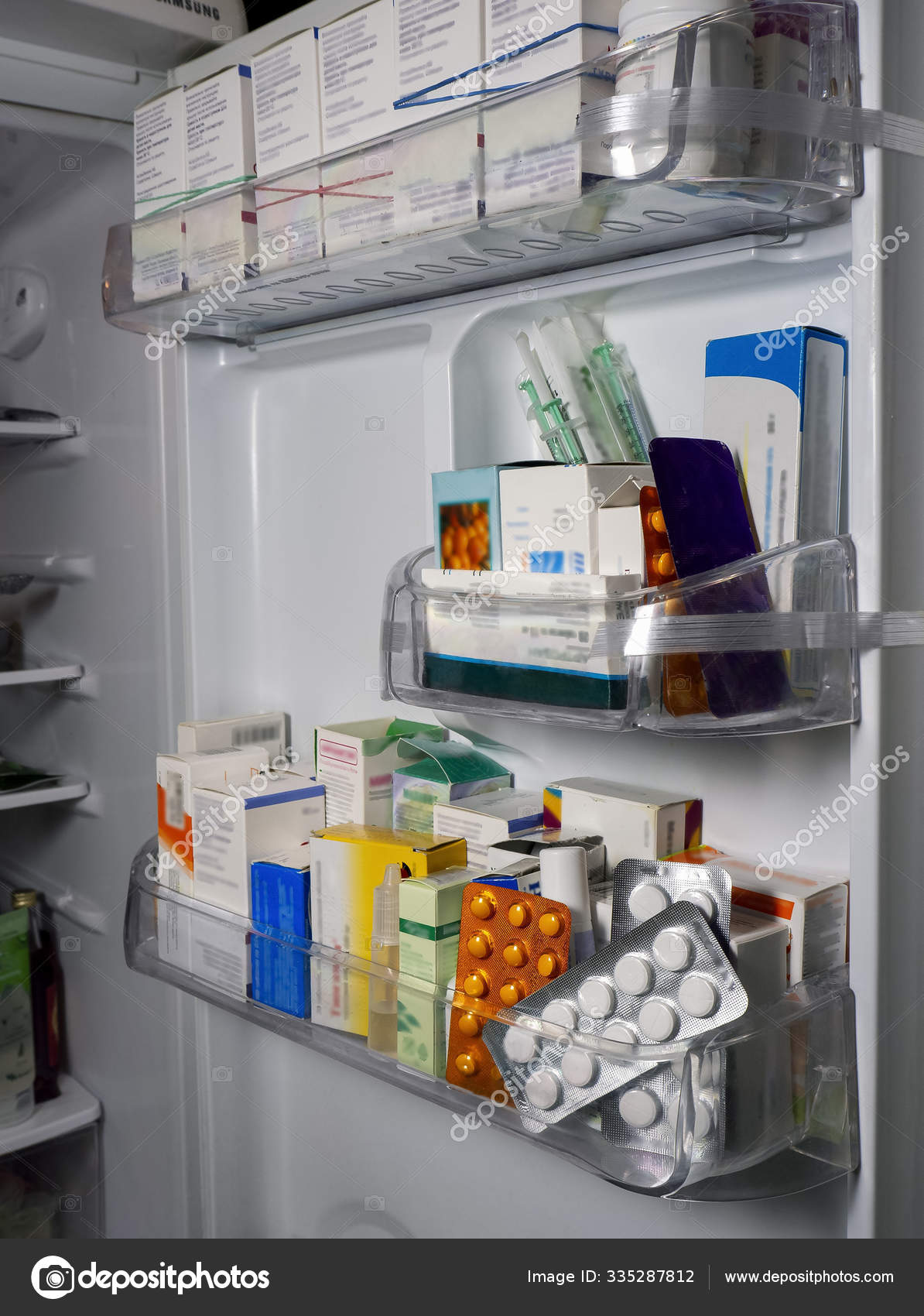 Background with medical drugs. On the shelves of the refrigerator door