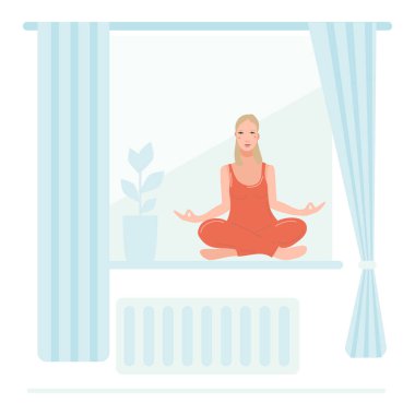 Genç ve güzel bir kadın odasının penceresinde oturmuş yoga yapıyor..