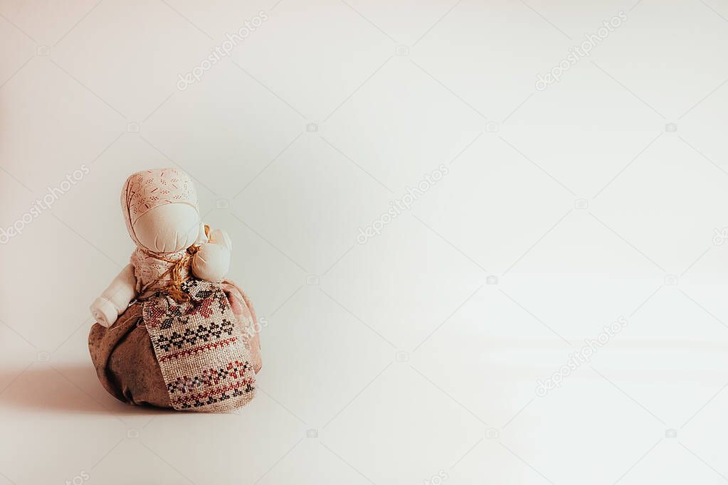 Handmade textile dolls on white background. Abundant dollsin handkerchiefs in ethnic style Ukrainian and Russian traditions,Slavic souvenir. Place for text. Background.