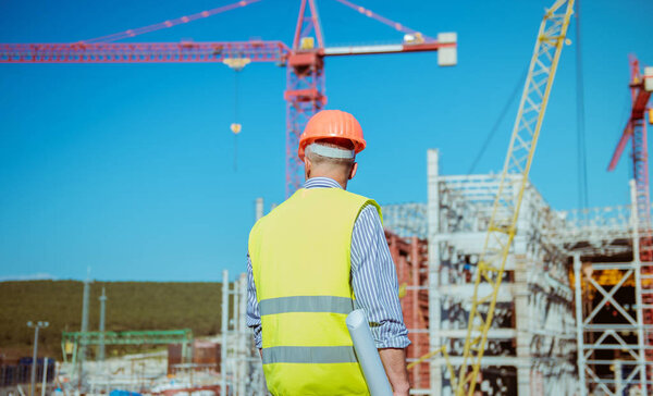 Portrait of a male engineer on a construction site background