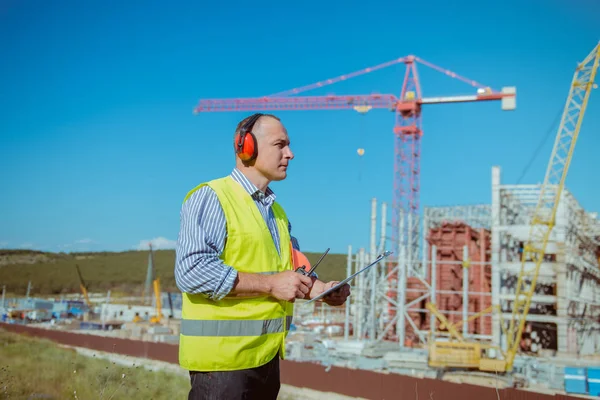 İnşaat site arka plan üzerinde erkek bir mühendis portresi