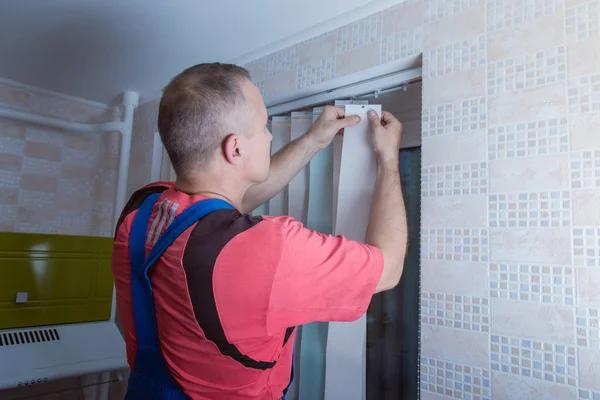Man is installing window blinds, — Stock Photo, Image