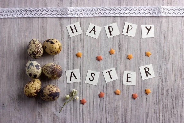 Happy Easter letters and easter eggs on the wooden table