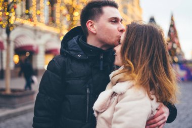 Sokakta sevgi dolu bir çift Noel arkaplanında.