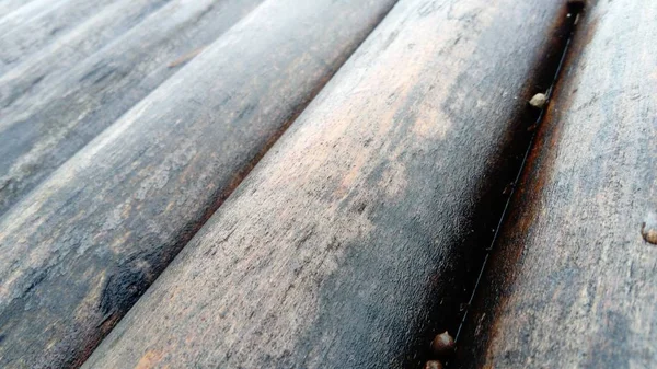 El efecto de la humedad en la madera. Un tronco de construcción para su uso en construcción sin aserrado longitudinal. Surtido de madera redonda. Fragmento de la construcción de troncos redondeados de madera . — Foto de Stock