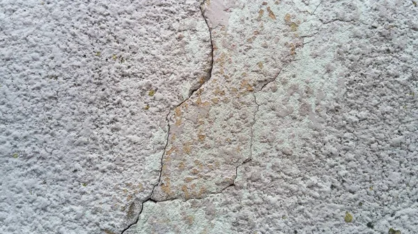 Crack on the wall of the house. Old plaster falls off the surface. Defect during construction. The effect of humidity on the structure. Violation of the technology of the construction process — ストック写真