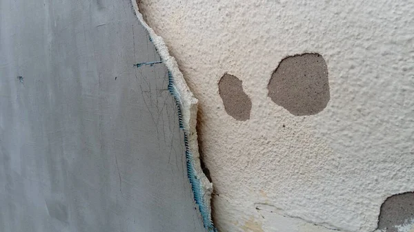 Grieta en la pared de la casa. El yeso viejo cae de la superficie. Defecto durante la construcción. El efecto de la humedad en la estructura. Violación de la tecnología del proceso de construcción —  Fotos de Stock