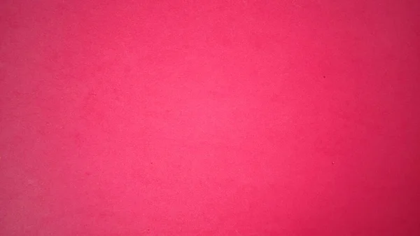 A sheet of bright pink paper with light vignetting around the edges. Intense fuchsia color. Saturated bright paint. Velvet paper texture. Background for greeting card or page. Valentine's Day — Stock Photo, Image