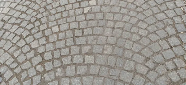 Praça Cobblestone no antigo bairro da cidade. Pedras quadradas e irregulares são azulejos. Contexto. Cinza suave, bege e marrom cores e tons. Fundo, espaço livre para texto — Fotografia de Stock