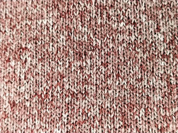Knitted pattern with the help of knitting needles or crochet. Knitted elastic according to the picture: one front loop, one wrong loop. Knitted warm item. Yarn red and white double color. Close-up — 스톡 사진