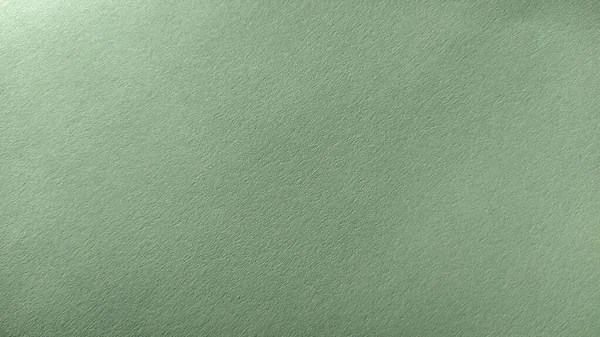 Uma folha de papel verde claro com vinheta na parte inferior. Verde calmo com textura de papel fino. Cor interior calmante — Fotografia de Stock