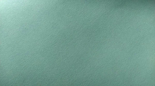 Uma folha de papel verde claro com vinheta na parte inferior. Verde calmo com textura de papel fino. Cor interior calmante — Fotografia de Stock