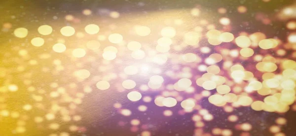 Mysterious abstract warm background or greeting card. Sun glare on a bright yellow background. The nuances of orange, yellow, pink, purple, beige and white. Beautiful bokeh effect.