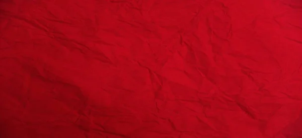 赤の美しい明るい背景。スカーレット不均一な色。カラーペーパーのシート。折り目のある紙の質感. — ストック写真