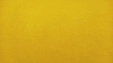 Güzel sarı bir arka plan. Yakın plan bir kağıt parçası. Saf neşeli bir renk. Parlak sarı tonda, samana yakın, parlaklığı olmayan altın rengi..