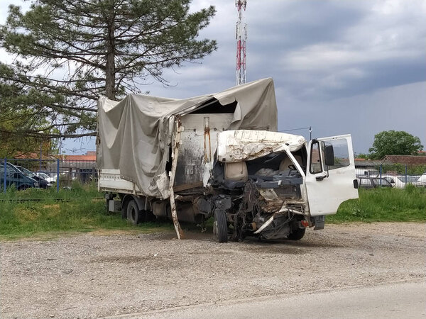 Broken truck. The consequences of an accident on the road. Damaged cab and car body. Car dump. Insurance case. Head-on collision. The result of falling asleep while driving or malfunctioning mechanisms.