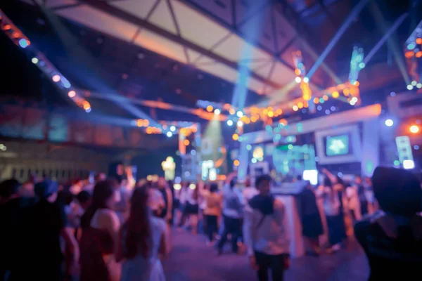 Crowd in front of concert stage with dancer blurred — Stock Photo, Image