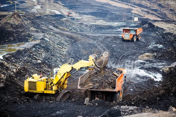 Mining dump trucks working in Lignite coalmine