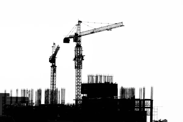 Construction site with cranes on silhouette background — Stock Photo, Image