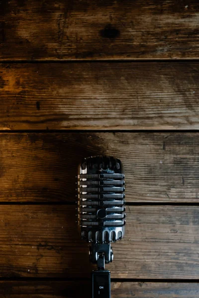 Retro microphone on dark wooden background — Stock Photo, Image