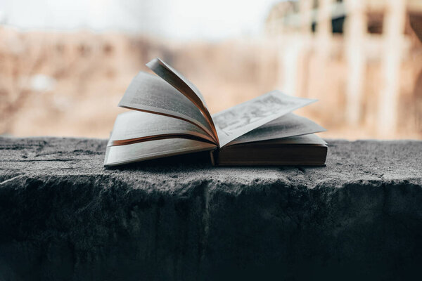 A book open on a concrete surface