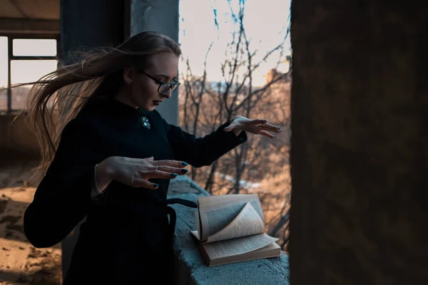 girl sorceress leafing through a book of spells