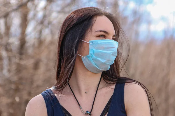 A young girl in the fight against the epidemic put on a medical mask