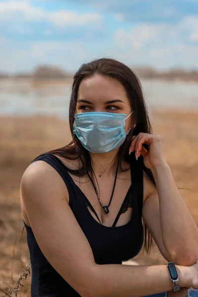 A young girl in the fight against the epidemic put on a medical mask