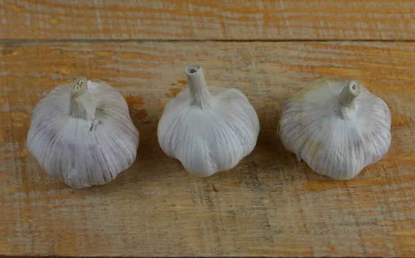 Frisse Smakelijke Knoflook Ligt Een Gele Houten Achtergrond — Stockfoto