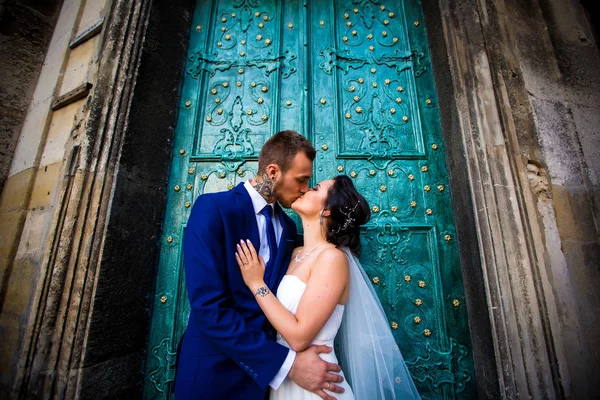 Brides look at each other on a background of blue door — Stock Photo, Image
