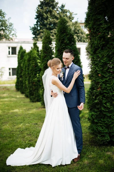 Sposa felice e sposo in piedi sotto l'arco di nozze — Foto Stock